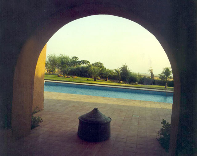 View looking through archway towards pool