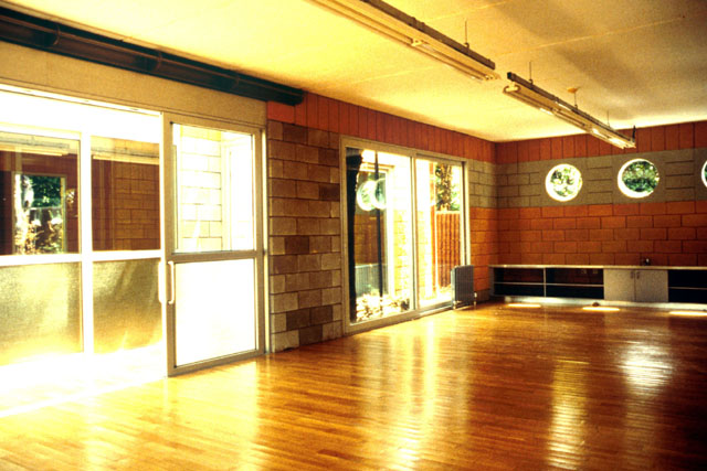 Interior view, showing mix of stone, wood, and glass to layer space and filter light