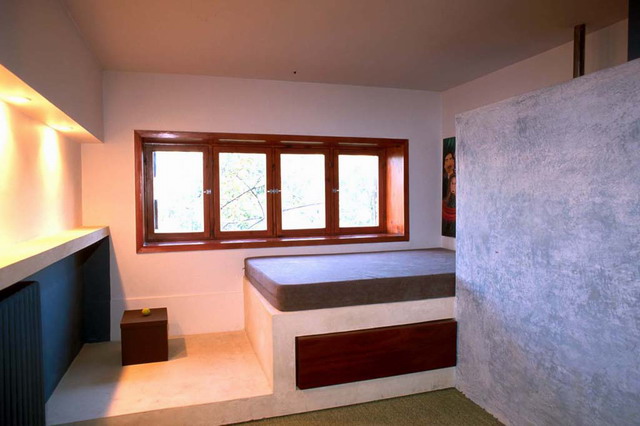 Upper floor of the clinic psychologist's private quarters, window giving a full view of the lemon trees in the patio, the bed consists of a concrete slab with a mattress