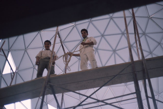 Interior detail under dome of workers on scaffolding
