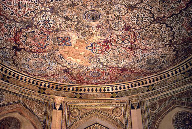 Interior view of circular, decorated ceiling and cornice