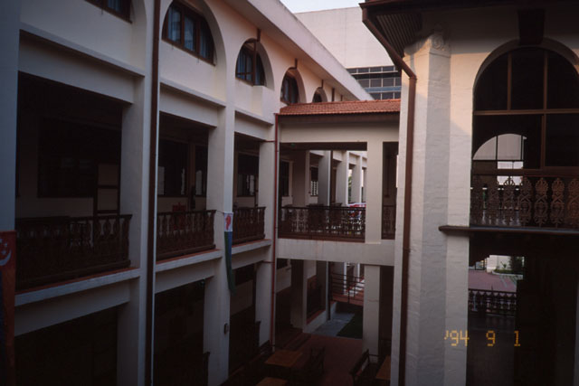 View from upper level across courtyard to second story aisles and walkways