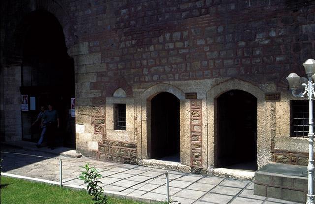 <p>Courtyard, exterior walls, built of alternating courses of stone and brick</p>