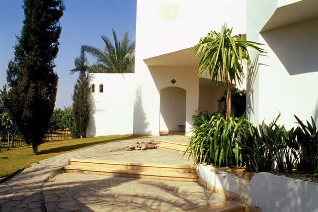 Nachar-Segeeny Museum - Stone pavement, museum garden with palms and fruit trees and the grass extending beyond the wrought iron barrier act as connections between the museum building and its agricultural surroundings