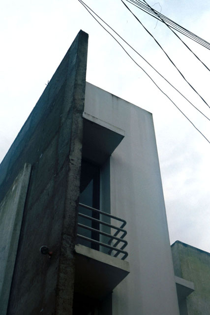 Exterior view showing concrete façade and modular form