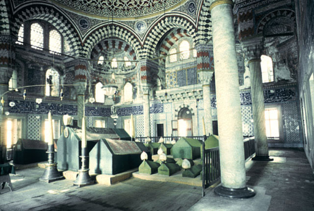 Interior view showing columns and pointed arches supporting the dome structure; the large sarcophagi of Selim II is placed opposite the main entrance, seen in the background