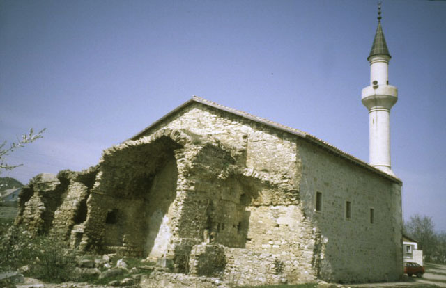 Exterior view from southwest showing ruined madrasa adjoining the mosque's qibla wall