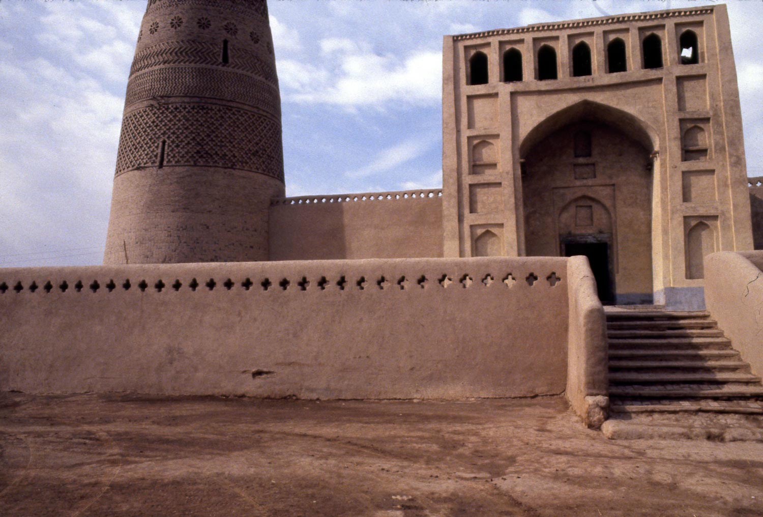 Steps leading up to terrace with mosque portal and minaret