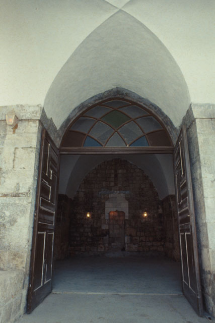 Exterior view to entrance toped with glazing under cross-vault entrance