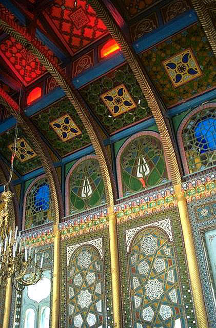 Interior detail view of stained glass and colored tiles