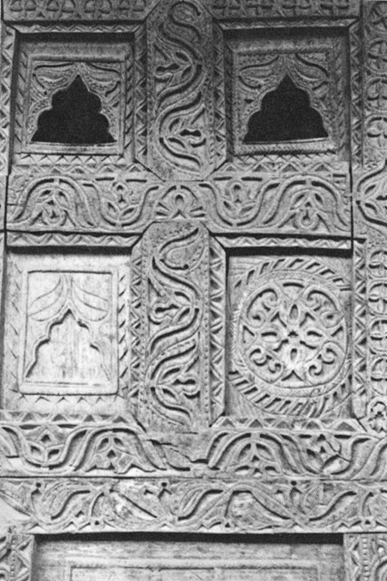 Woodcarving detail with <i>turiangkishe phiti</i> motif (lower right panel) and niches