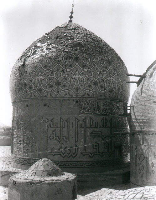 Darb-i Imam - Exterior view of large (southern) dome from northeast, showing remnants of tile decoration.