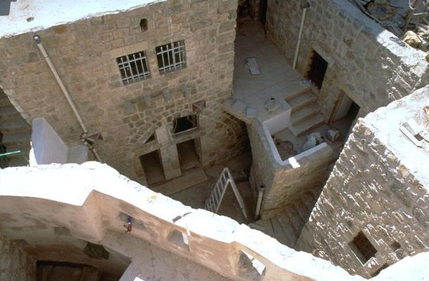 Aerial view into a hosh, a two or three storey residence assymetrically arranged around a courtyard