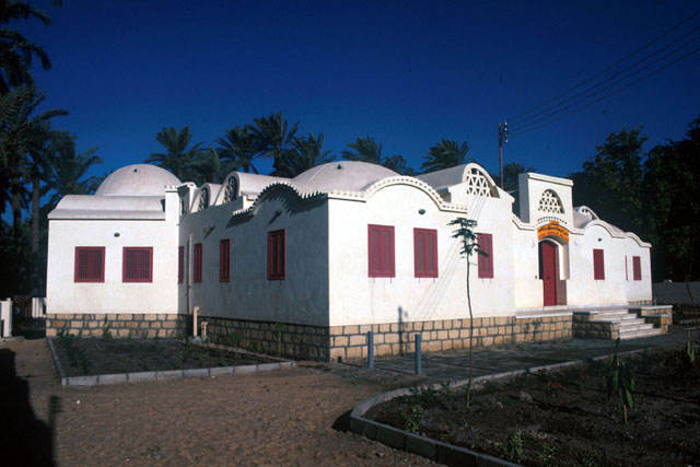 Exterior view showing white-washed façade of domed and vaulted house