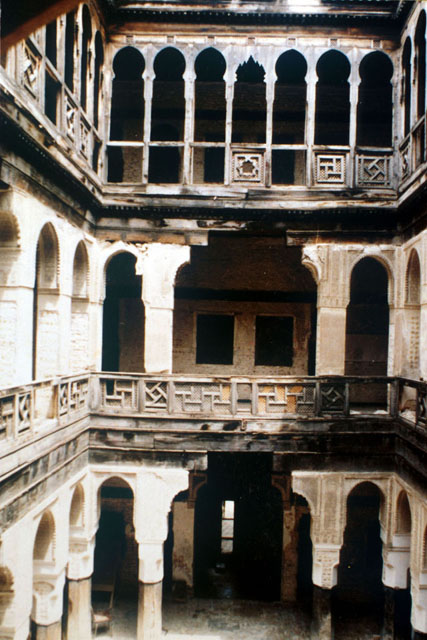 View from second story balcony across courtyard before restoration