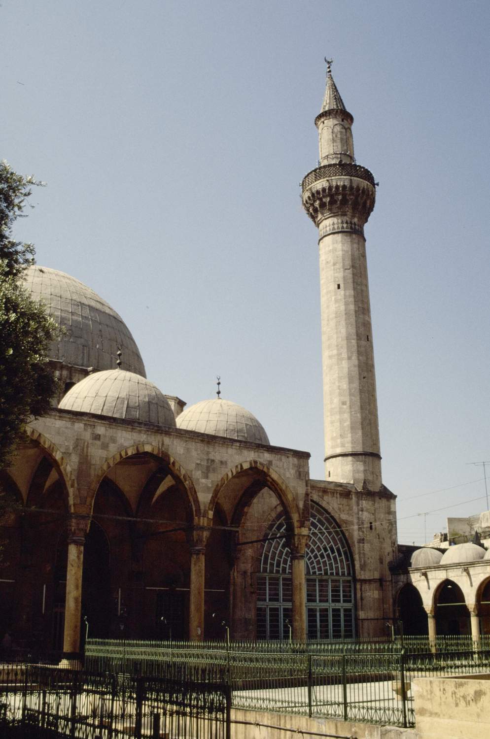 Southward view of minaret and mosque exterior.
