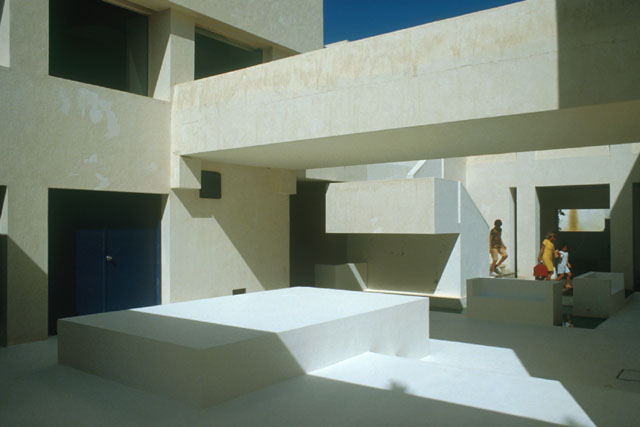 Exterior view showing projecting linear beams and benches