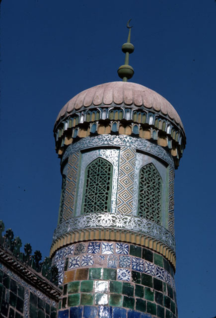 Turret with screened windows, inverted lotus dome and finial at a corner of the mausoleum roof