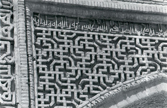 Detail of northwest iwan in the second courtyard, showing brick decorations in the left spandrel and part of horizontal inscription