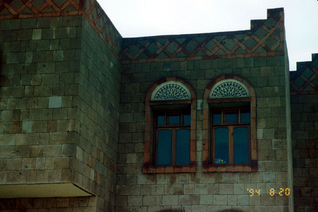 Alguraf Housing - Exterior detail showing inset wooden window frames