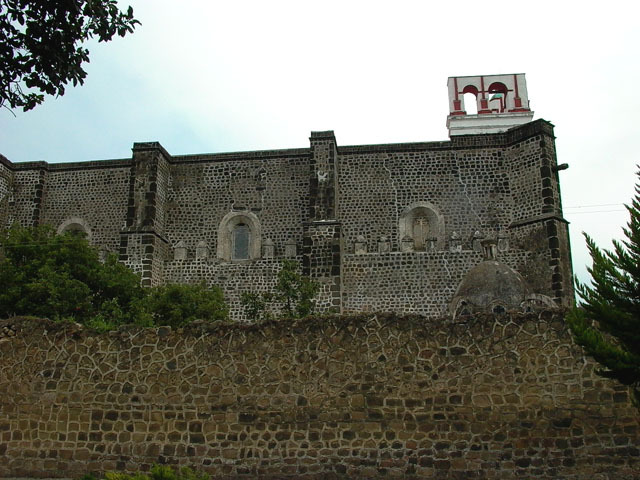 Exterior view of the side elevation showing buttresses, window niches, and merlons