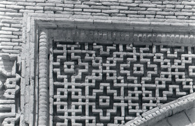 Detail of portal screen, showing brick motifs in left spandrel