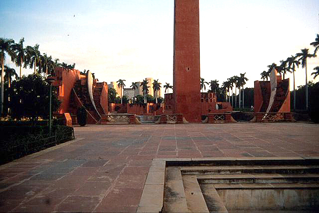 View of the Jantar Mantar complex from the north. The Samrat Yantra is visible in the foreground, with the tallest portion of the gnomon in the center and the quadrants on either side of it. The Jai Prakash Yantra is partly visible in the background behind the gnomon