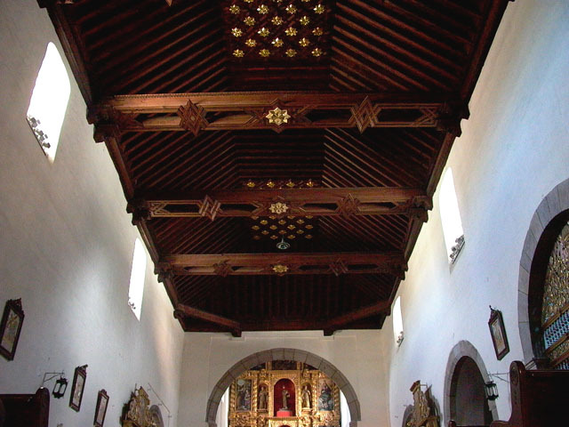 Interior view of wooden ceiling with altar beyond
