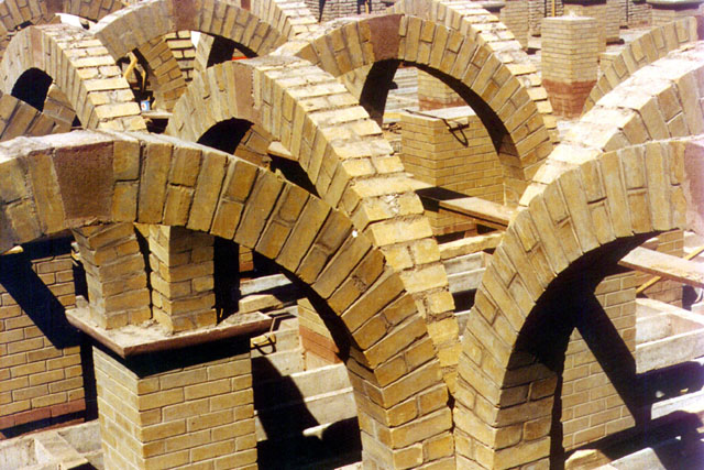 Exterior detail during construction showing piers that carry arches