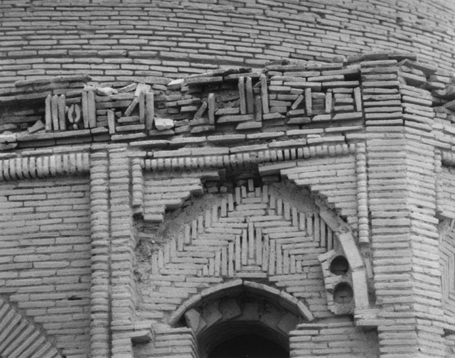 Exterior detail showing remains of brick inscriptive frieze above northwest archway
