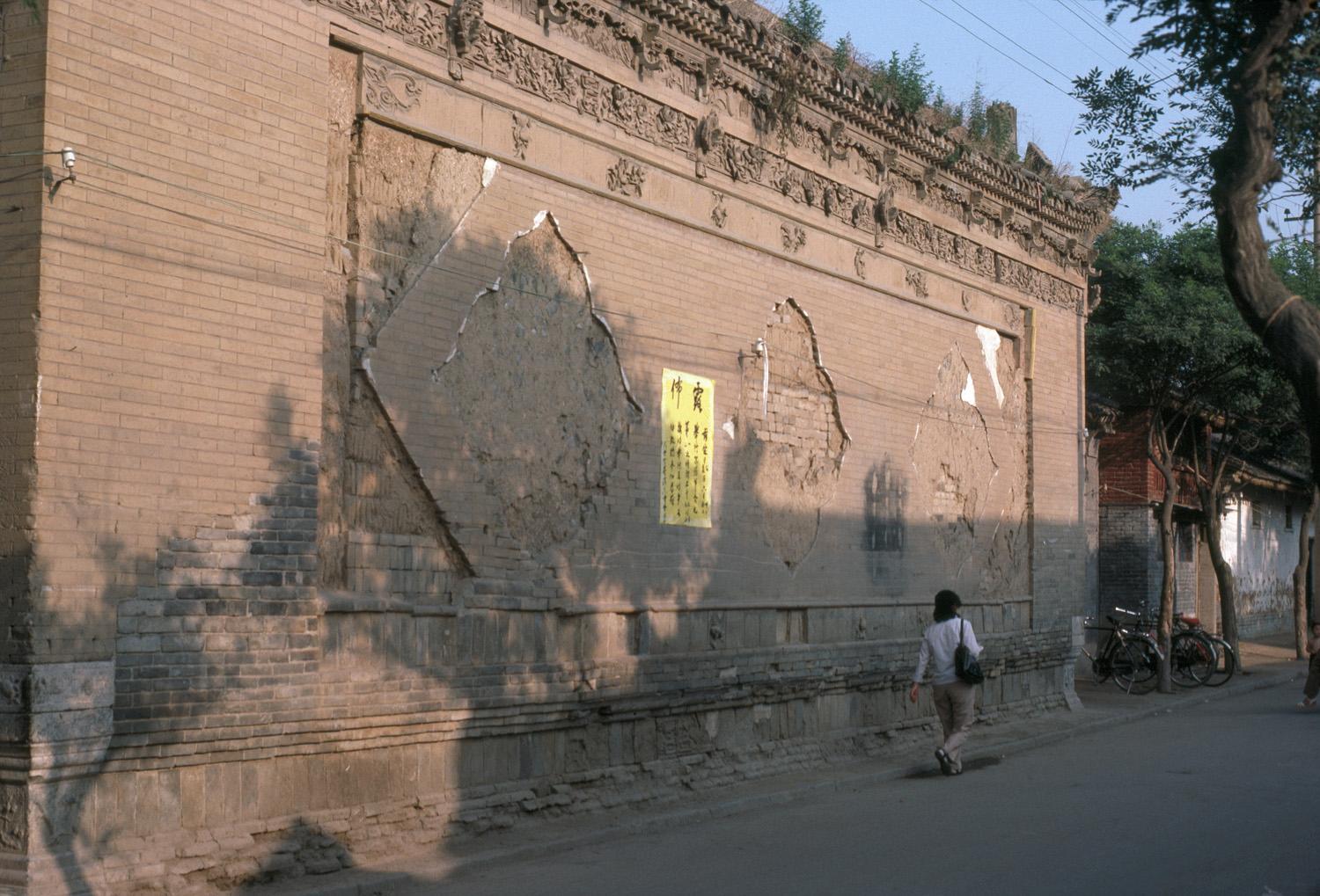 View showing damage to precinct wall with the removal of sculptural lozenges