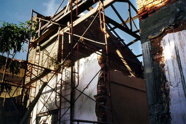 Damaged walls with scaffolding