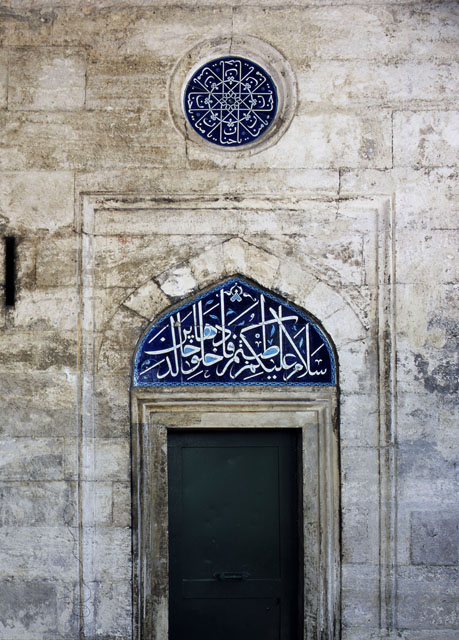 Detail of mosque portico showing underglaze Iznik tile lunette and roundel