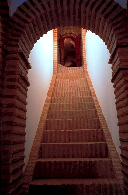 Interior, view to brick stiarcase, looking up