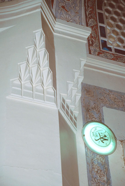 Interior detail from showing stalactites decorating pier and painted tile designs on walls