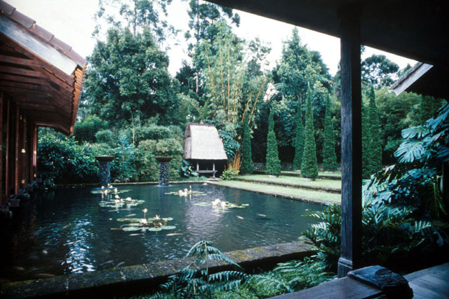 View of pond encased by porticos and steps to garden