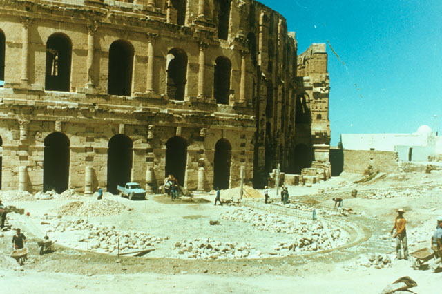 Exterior view showing excavation team at work on façade