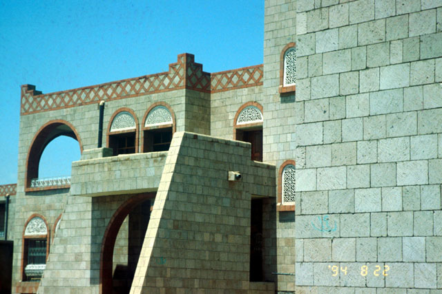 Alguraf Housing - Exterior view showing cinder block construction with braided border design