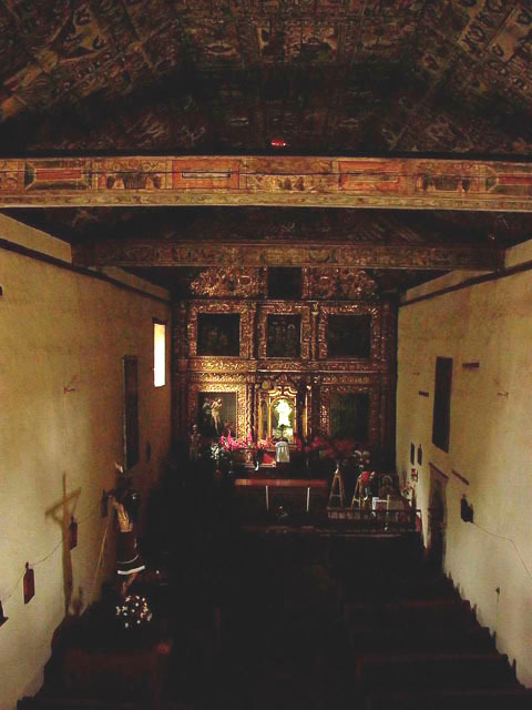 Interior view towards the altar showing also the painted wooden ceiling
