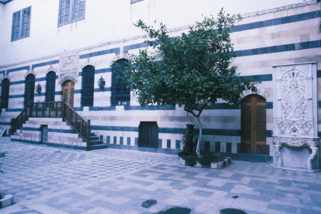 Exterior view showing relation between marble ablutions fountain and wooden entrance