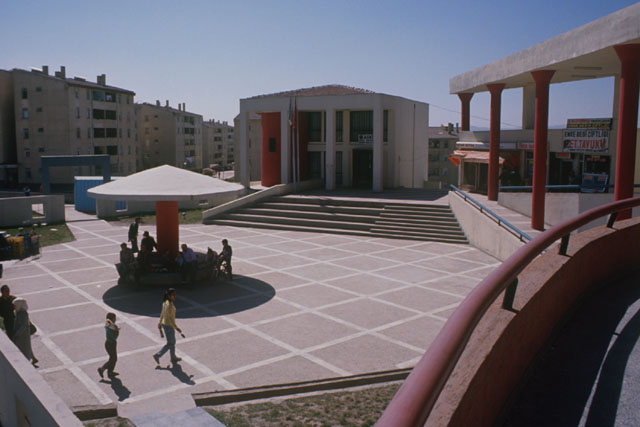 Elevated view showing piazza with resting places and grid pattern pavement