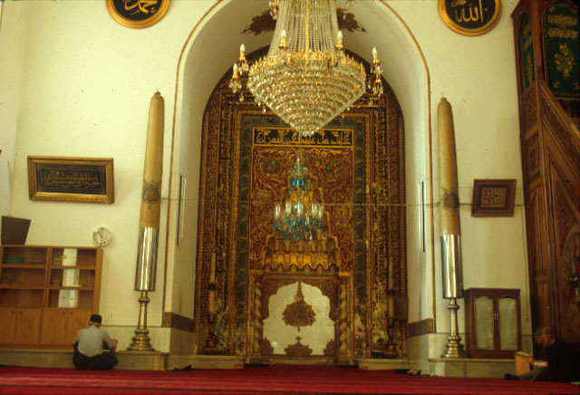 The restored mihrab of the mosque with the wooden minbar to the right