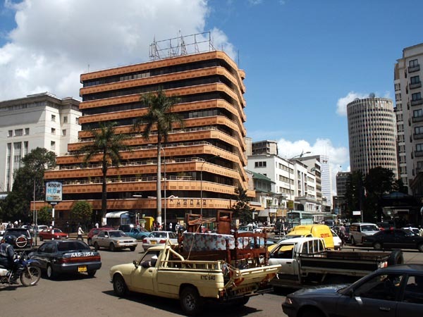 General view of Kenyatta Ave at Kimathi Street, showing Kimathi House on left and Nairobi Hilton in the right background