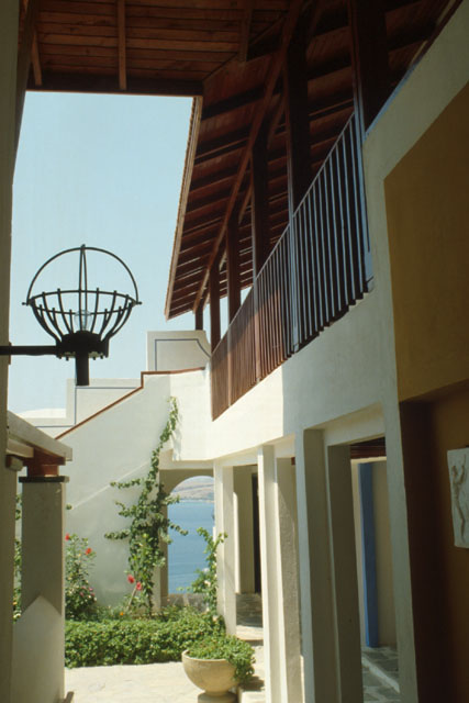 Exterior view showing wooden ceiling and iron light fixtures