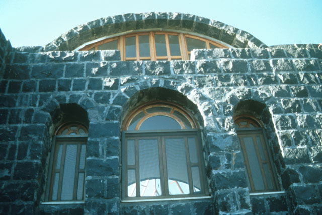 Exterior detail showing stone façade with wood framed windows