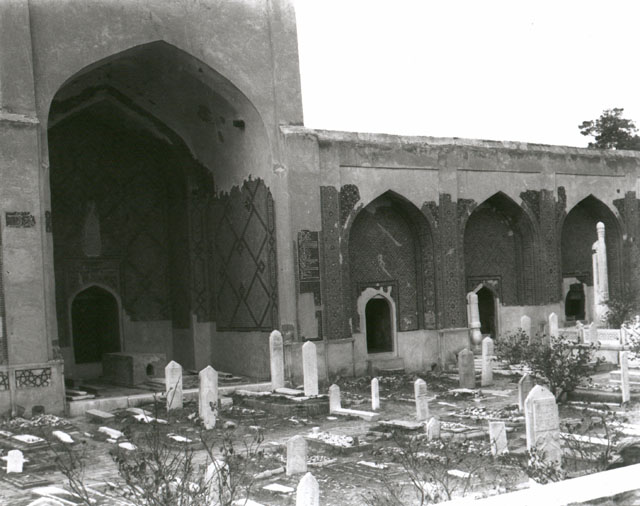 View of northwest iwan in shrine courtyard, with tombstones