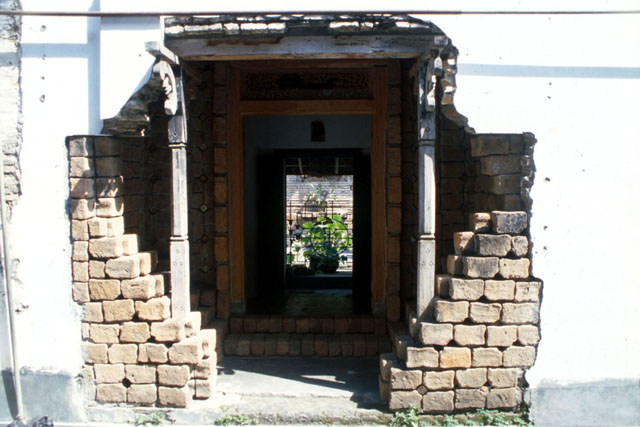 Exterior view showing artful entrance composed of brisk, stone and plaster