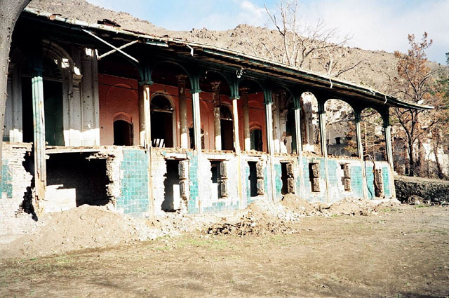 Exterior view from west, prior to restoration, showing extent of damage in conflicts