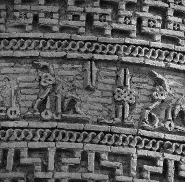 Detail view of the brickwork epigraphic frieze below the cornice