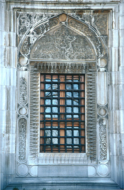 A window on the northern façade, decorated with interlaced flower motifs and inscriptions carved onto marble tympanum and moulding